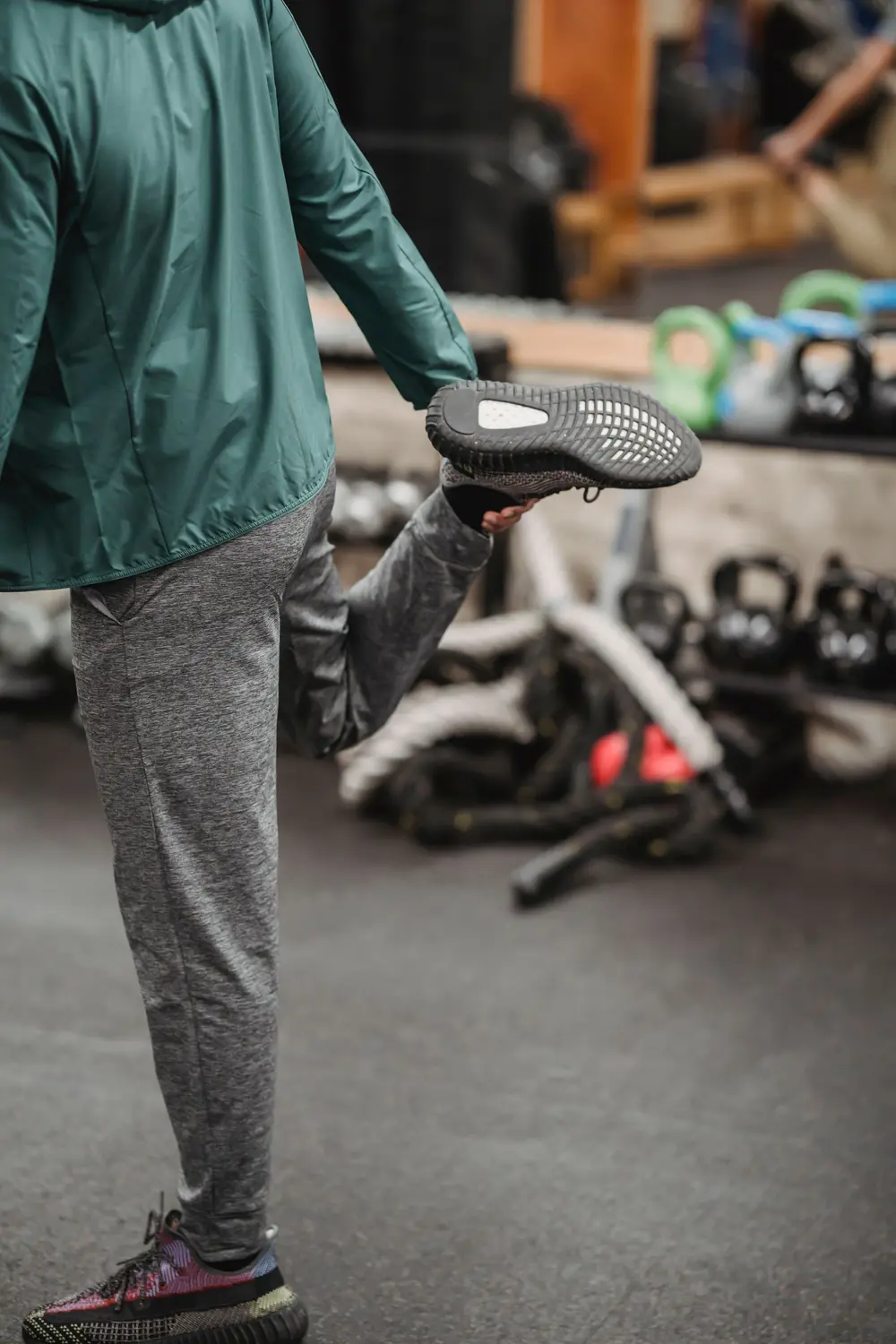 Athlete stretching the knee and leg during gym training