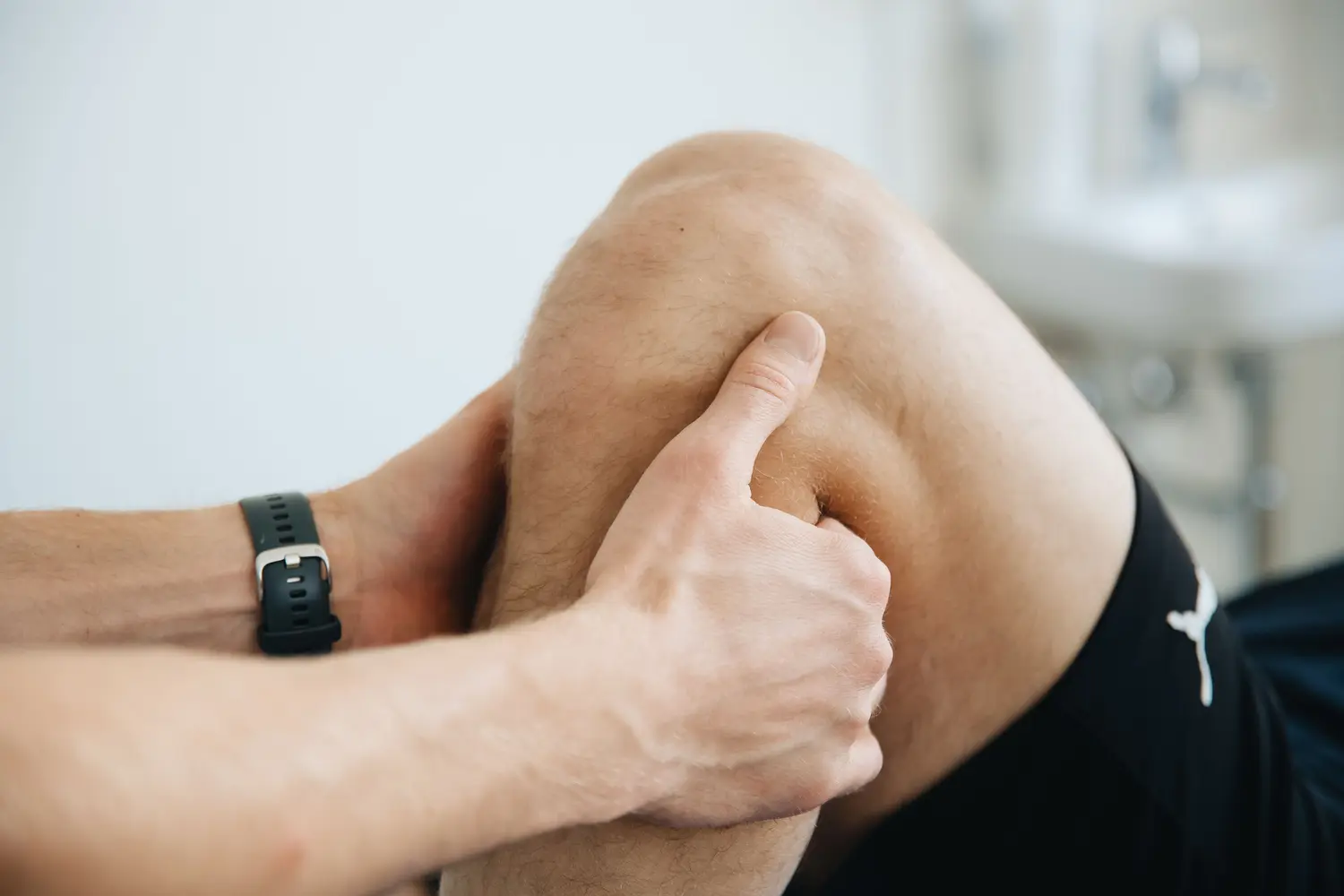 Close-up clinical assessment of a patient's knee